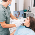 Doctor using Medit i700 3D Digital Scanner to perform a dental scan on a female patient.